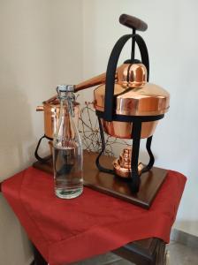 a juicer and a glass bottle on a red cloth at EverGreen in Kavala