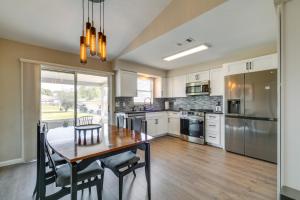a kitchen with a wooden table and a dining room at Florida Vacation Rental with Enclosed Porch! in Beverly Hills +19 photos