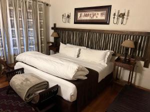 a hotel room with two beds and a window at Cardoso Kitchen Bar & Lodge in Johannesburg