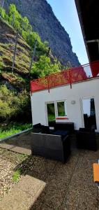 a building with black chairs in front of a mountain at Ferienwohnung zentrale Lage in Idar-Oberstein