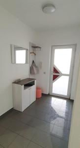 a white kitchen with a counter and a door at Ferienwohnung zentrale Lage in Idar-Oberstein