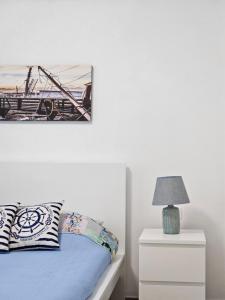 a bedroom with a bed and a picture on the wall at Casa Marina in Ortona