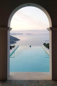 a view of a swimming pool through an archway at Sundance - Fabulous & Large 4-Bedroom Private Villa in Sivota
