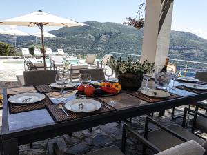 a table with wine glasses and fruit on it at Sundance - Fabulous & Large 4-Bedroom Private Villa in Sivota