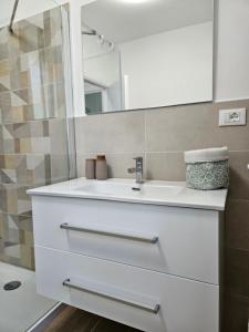 a bathroom with a white sink and a mirror at Casa Marina in Ortona +8 photos