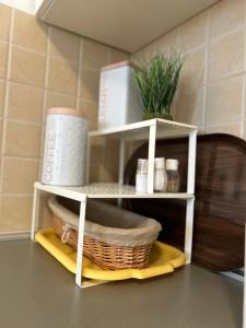 a shelf in a kitchen with a basket on a counter at Apartment David in Biograd na Moru