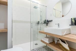 a bathroom with a glass shower and a sink at Limehome Madrid Calle de Luchana - estancia temporal in Madrid