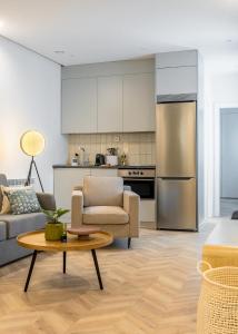 a kitchen and living room with a couch and a table at Limehome Madrid Calle de Luchana - estancia temporal in Madrid