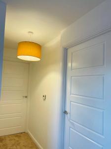 a room with a door and a light at Anox serviced Apartments 2 in Newcastle upon Tyne