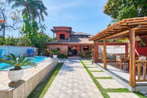 a house with a swimming pool and a pavilion at Casa Carvalho in Paraty