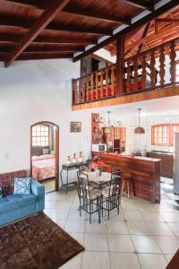 a living room with a blue couch and a table at Casa Carvalho in Paraty