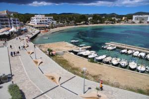 a group of boats parked in a harbor at Apartamentos Playa Sol in Es Cana