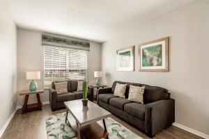 a living room with a couch and a table at Tiger Lilly at Ellis Exclusive Villas in Kissimmee