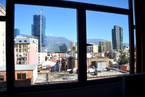 uma vista da cidade a partir de uma janela em Sunny Flat in the Center of Tirana, 2 min. walk em Tirana
