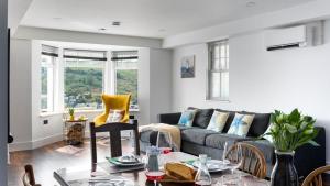 a living room with a couch and a table at HipNautic, Mevagissey, Sleeps 6 in Mevagissey