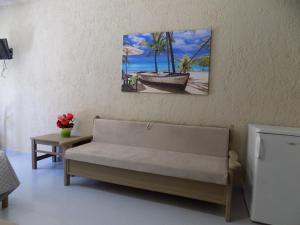 a living room with a couch and a painting on the wall at Afrodite Spacious Apartments! in Agia Effimia