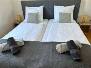 two beds with towels on top of them in a bedroom at Apartment David in Biograd na Moru +44 photos