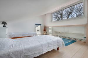 En eller flere senge i et værelse på Maison à 300 m de la plage!