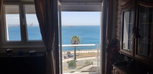 a view of the ocean from a room with a window at Sines Ocean View Apartment in Sines