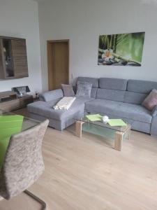 un soggiorno con divano e tavolo di Ferienwohnung Rote-Villa 2 a Marienberg