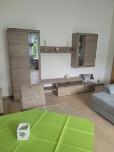 a living room with a large mirror and a couch at Ferienwohnung Rote-Villa 2 in Marienberg
