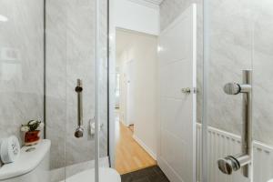 a white bathroom with a shower and a toilet at Holloway Road Double rooms - 5 in London