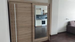 a large wooden door in a room with a kitchen at Comfy room near city centre in Tallinn