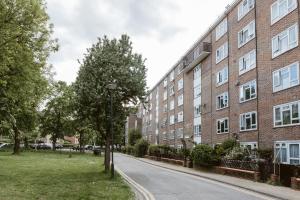 an empty street in front of a brick building at Holloway Road Double rooms - 5 in London