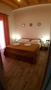 a bedroom with a large bed with two towels on it at Casanuova Flat, City Center in Olbia
