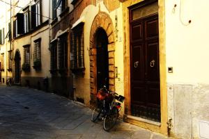 a bike parked next to a building with a door at Altana Panoramic in Lucca