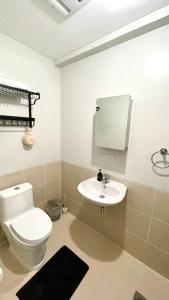 a bathroom with a toilet and a sink at Verdon Parc Condo 1 Bedroom in Davao City