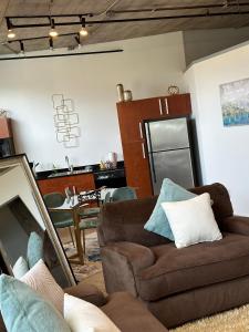 a living room with a couch and a kitchen at Luxury Cozy Loft Downtown STL in Saint Louis