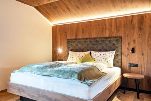 拉伊翁的住宿－Wieshof Idyll，一间卧室设有一张带木墙的大床