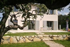 una casa con una pared de piedra frente a un edificio en Mas Provençale au calme Piscine, en Vacqueyras