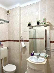 a bathroom with a toilet and a sink at Charming House 2 in Amadora