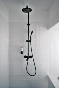 a shower with a shower head in a bathroom at Casa do Santo - Wine & Tourism in Provesende