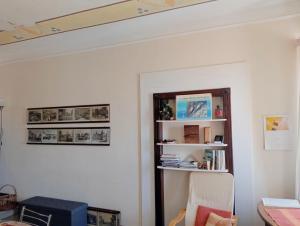 a room with a white wall with a book shelf at Torre Tonda in Sassari