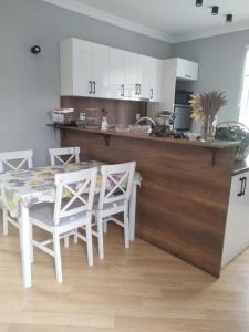 a kitchen with a table and chairs and a counter at Novxani jorat beach area in Sumqayyt