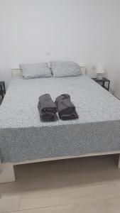 a bed with two brown towels on top of it at BeachFront House in Málaga