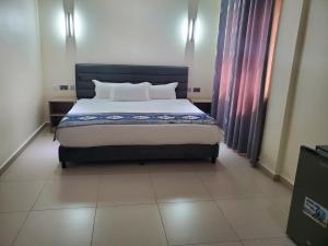 a bed in a room with a large bed sidx sidx sidx at Lagoonbeachhotel in Keta