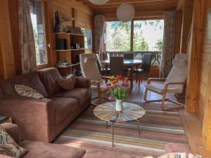 ein Wohnzimmer mit einem Sofa und einem Tisch in der Unterkunft Chalet de Vantaa in Les Gets