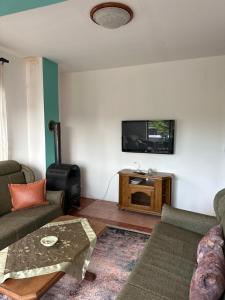 a living room with two couches and a flat screen tv at Heart apartments in Sarajevo