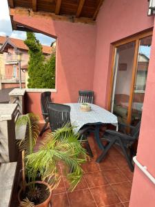 a patio with a table and chairs on a balcony at Heart apartments in Sarajevo
