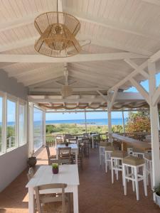 a restaurant with tables and chairs and a ceiling at Artemis Hotel-MeRaki Restaurant in Frangokastello