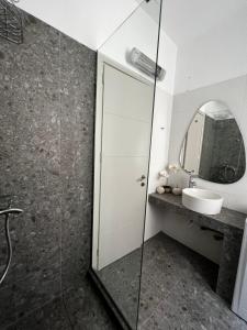 a bathroom with a shower and a sink and a mirror at Casa d' arte in Corfu Town