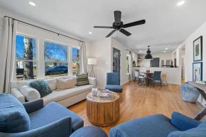 a living room with a couch and a table at The Olive Branch - Hot Tub & Walk to Main in Fredericksburg