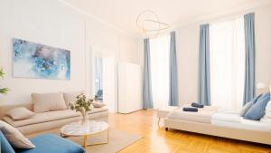 a white living room with a couch and a table at Spacious and Near Metro, Perfect for Groups of 14 in Vienna