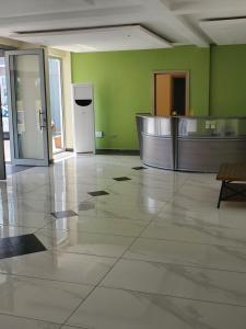 an empty lobby with a refridgerator in a building at Lagoonbeachhotel in Keta