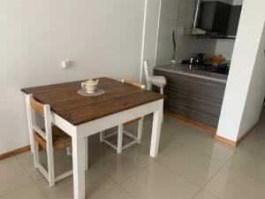a wooden table and chairs in a kitchen at Belvedere in Puerto Madryn +7 photos