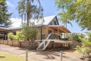 a house with a staircase in front of it at Riverscape Cottages in Augusta